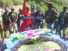 National Committee of West Papua (KNPB) members and Zamotok Lokon's family take a picture during his funeral. Lokon reportedly died while serving his sentence at Abepura Prison in Jayapura, Papua, on Monday. 