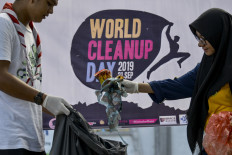 Environmental activists get down and dirty on mass cleanup day