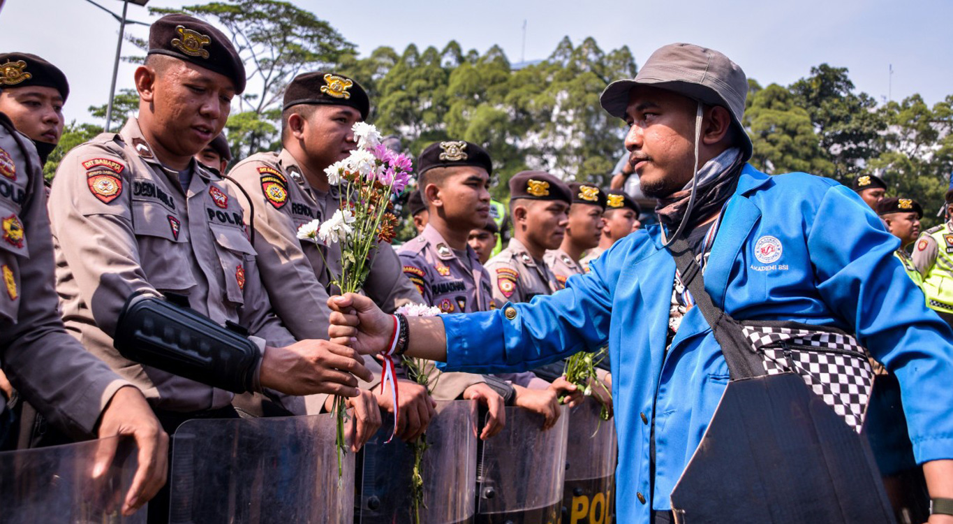 Flower power: Students in Jakarta hand out blossoms as sign of peaceful protests