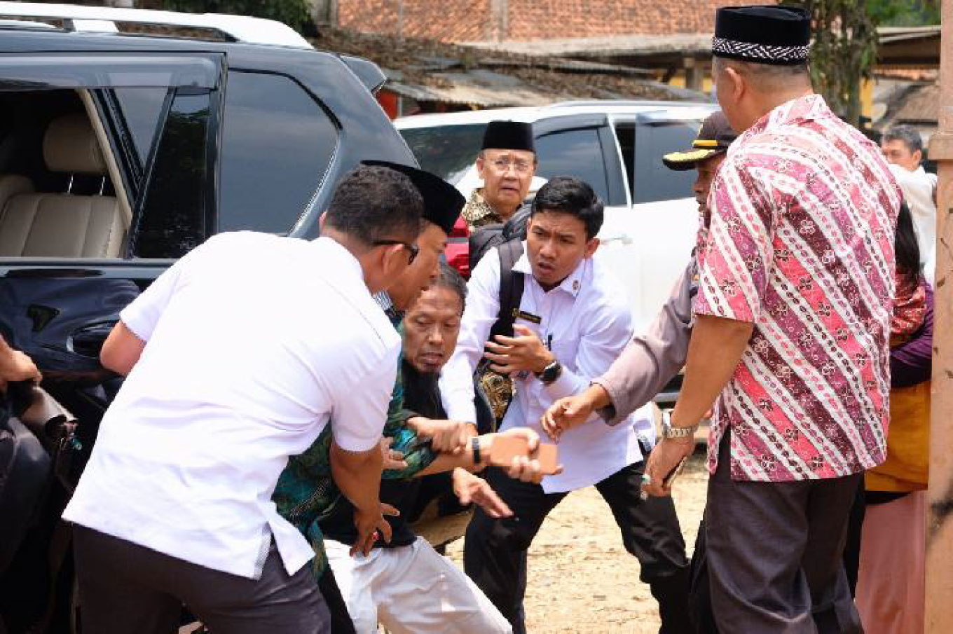 Coordinating Political, Legal and Security Affairs Minister Wiranto during a visit to Banten on Thursday afternoon, just a moment before a man tries to attack him with a knife.