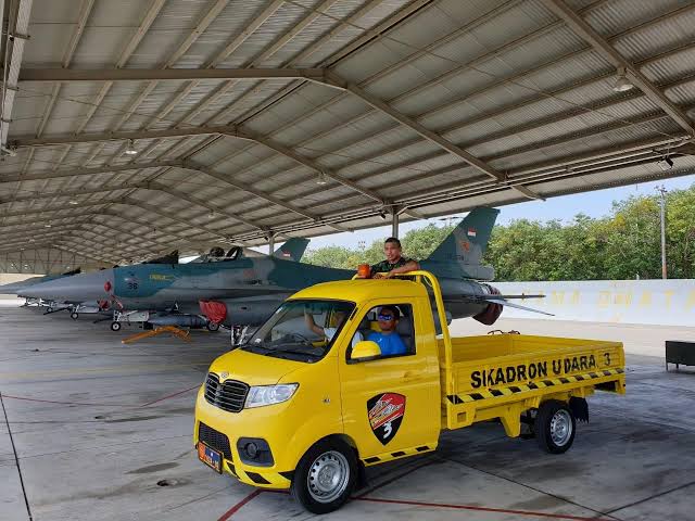 A flight line team for Squadron 3 of the Iswahjudi Air Force Base pose inside a newly arrived pickup truck from locally made car brand Esemka in Magetan, East Java.