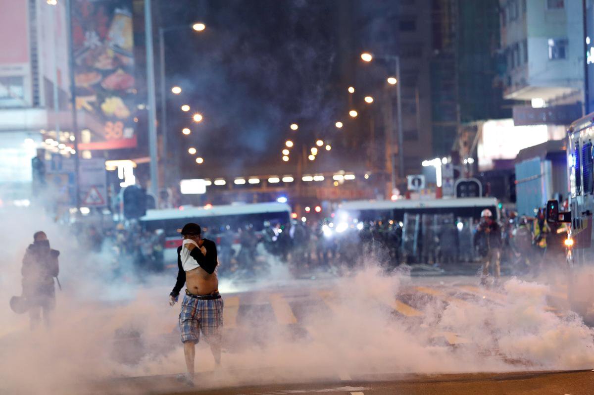 Hong Kong protesters hurl petrol bombs after police fire tear gas to clear rally