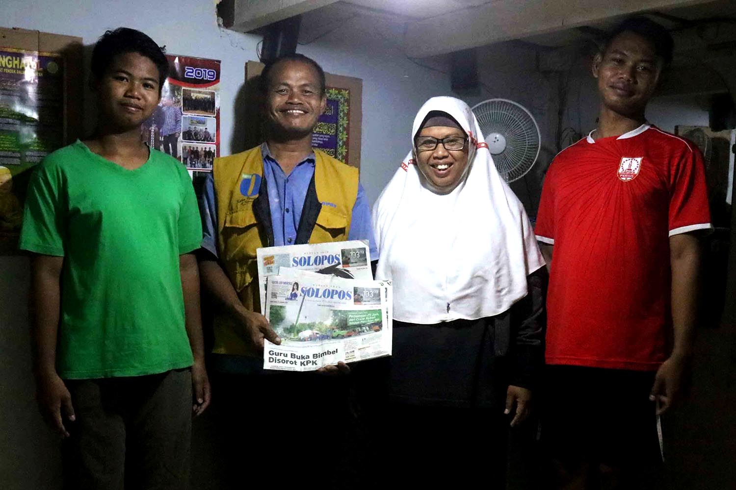 Newspaper deliveryman Sarip alongside his family. Sarip believes his job is a source of blessings for his family. JP/Maksum Nur Fauzan