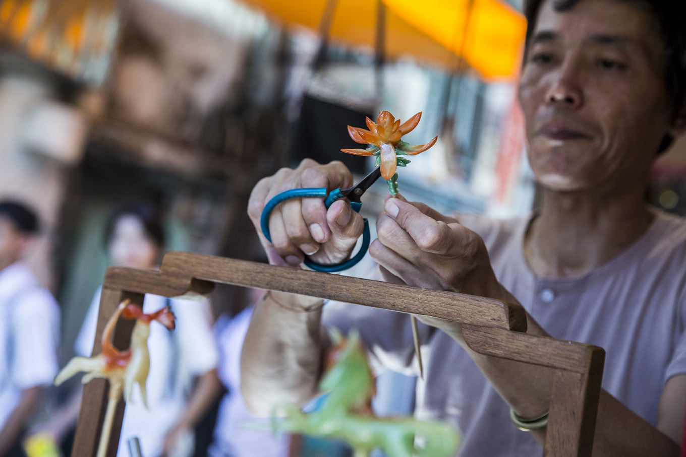 This photo taken on June 6, 2019 shows shopkeeper Louis To making a flower out of candy at his shop on Cheung Chau Island in Hong Kong. The shop on Cheung Chau, a small island in the waters west of Hong Kong's famous Victoria Harbour, has become a must-see for visiting tourists.