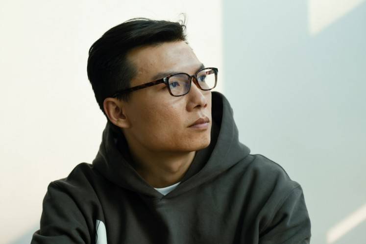 This picture taken on Oct. 23, 2019 shows Chinese sci-fi writer Chen Qiufan, also known as Stanley Chen, during a photo shoot in Beijing. China's millennials are increasingly pursuing happiness and sustainable living rather than wealth and luxury, award-winning sci-fi writer Chen Qiufan says, insisting the nation's youth are waking up to environmental issues.