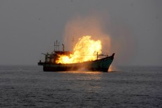 A Thai-flagged fishing boat apprehended for illegal fishing activities is scuttled by Indonesian authorities in the waters of Langsa Aceh, Oct. 20, 2015. 