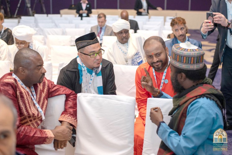 Exchanging ideas: Swami Chidakashananda from Sri Lanka (second right) talks to participants representing other faiths during the international conference on tolerance on Saturday.