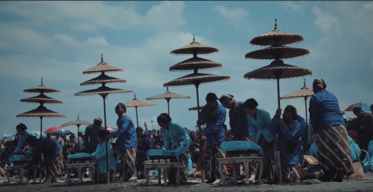 Sacred harmony: Participants of the Labuhan ceremony lay out offerings on a beach in Kediri, East Java, as depicted in 'The Untold Story of Java Southern Sea'.