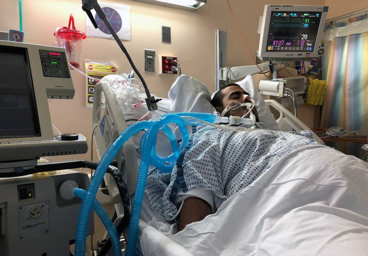 This undated family photo shows Gregory Rodriguez at a hospital in New York. With a raging fever, vomiting and diarrhea, Rodriguez thought he had some kind of bug when he checked himself into the emergency room at a New York hospital in September. Two days later, he was unconscious, hooked up to an artificial lung and a candidate for a double lung transplant.