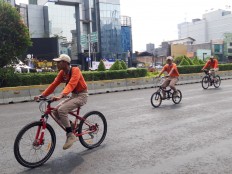 On patrol: Jakarta Public Order Agency (Satpol PP) officers patrol Jl. Sudirman during Car Free Day to look out for street vendors.