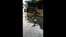 Video: Bandung road becomes river of trash. Man throws more in.