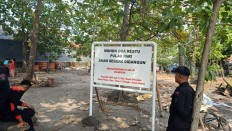 Signs announcing construction project on Pari Island put up amid ongoing land dispute