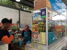 ‘No more coins’: Micromerchants embrace cashless payments with direct assistance