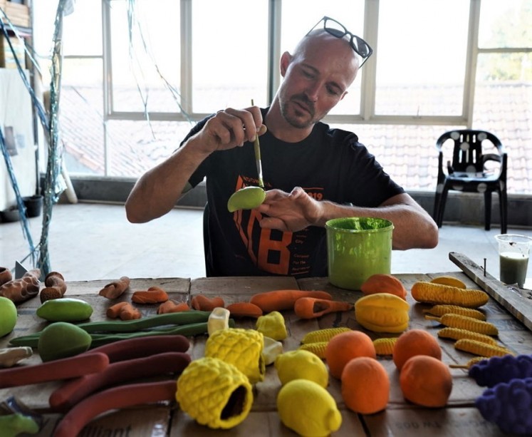 Work in progress: Artist Christian Elovara Dinesen paints the clay fruits at a studio for his 'Super Food' public art project in Jatiwangi Art Factory, Majalengka in West Java.