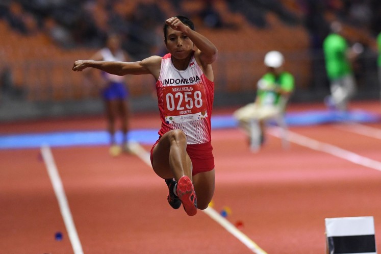 Indonesian track and field silver medalist Maria Natalia Londa competes in the women’s triple jump during the the 30th Southeast Asian (SEA) Games at New Clark Athletics Stadium in the Philippines on Saturday. 