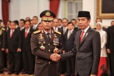 President Joko "Jokowi" Widodo shakes hands with National Police chief Gen. Idham Azis after the police general's inauguration as the nation's top cop at the State Palace on Nov. 2, 2019. (JP/Seto Wardhana)