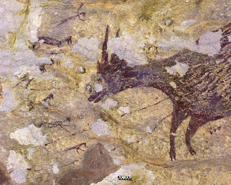 This handout photography released by Griffith University on December 11, 2019, shows cave art inside Bulu Sipong 4, Sulawesi, Indonesia. - A hunting scene painted 44,000 years ago, the oldest known to date, whose half-human, half-animal representations suggest a successful artistic culture, or even the beginnings of a religion, was discovered in a prehistoric cave in Indonesia, has been revealed in a study on December 11. 