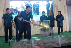 Jakarta Governor Anies Baswedan shovels sand into a box to symbolize the kick off of the Jakarta administration's second affordable vertical housing project called Nuansa Cilangkap in Cilangkap, East Jakarta on Thursday, Dec. 12, 2019.