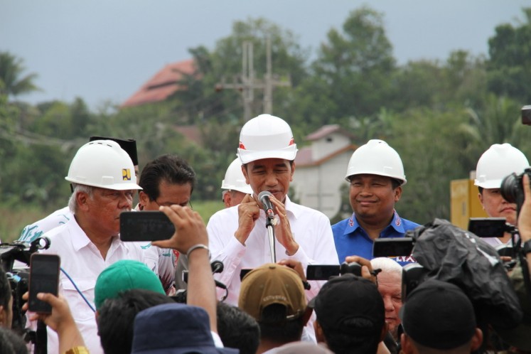 President Joko “Jokowi” Widodo speaks to journalists after the inauguration of three sections of Balikpapan-Samarinda toll road in in Samboja, Kutai Kertanegara Regency in East Kalimantan on Tuesday.