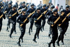Protect and serve: The National Police’s Mobile Brigade performs during its 73rd anniversary at the National Monument in Jakarta on July 10.