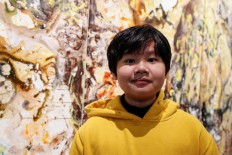 Xeo Chu, a Vietnamese art prodigy, poses in front of one of his pieces before his debut solo exhibition at the Georges Berges Gallery in New York City, New York, US, on December 18, 2019. 