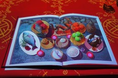 A scene depicting ingredients for Chinese cuisine, projected on a book in a dining experience with Le Petit Chef at Grand Hyatt Jakarta.