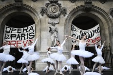 Paris Opera dancers perform in front of the Palais Garnier against the French government's plan to overhaul the country's retirement system, in Paris, on Dec. 24, 2019.