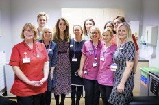 A handout photograph released by Kensington Palace on December 27, 2019 shows Britain's Catherine, Duchess of Cambridge, posing with staff during the time in November she spent at Kingston Hospital’s Maternity Unit. 