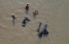 Residents try to save their belongings amid the floods that struck Jl. Jatinegara Barat in Kampung Pulo, East Jakarta on Jan. 2.
