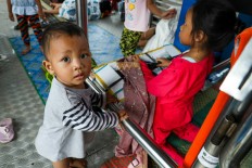Shelter from the storm: Dozens of flood victims occupy a Transjakarta bus shelter in Jembatan Baru, West Jakarta, on Friday. Without access to a proper evacuation center, residents of the Rawa Buaya area said they were forced to use the bus shelter after their homes were inundated by floodwater.
