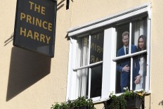 A cut-out of Britain's Prince Harry, Duke of Sussex, and Meghan, Duchess of Sussex is displayed in a window of The Prince Harry pub in Windsor, west of London on January 9, 2020. 
