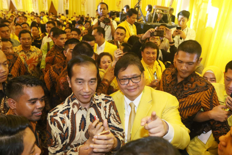 President Joko "Jokowi" Widodo (left) poses with Golkar party chairman Airlangga Hartarto (right) during Golkar party's National Congress on Dec. 3, 2019 in Jakarta. 