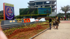 Residents visit the newly opened town square in Depok, West Java, on Sunday. Some facilities have been damaged, including the town square’s signage.
