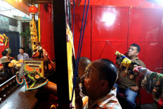 Team work: Puppeteers perform behind a screen at a wayang potehi (glove puppet) show. JP/Maksum Nur Fauzan