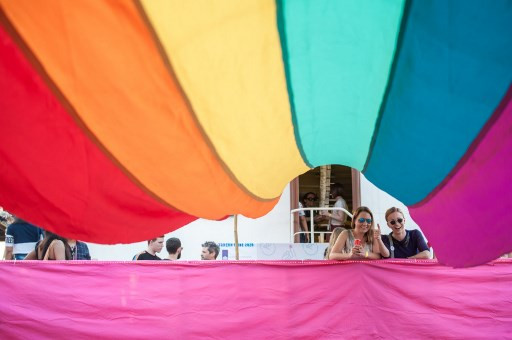 Members of the lesbian, gay, bisexual, and transgender (LGBT) community pose for photos under a rainbow flag displayed on a boat during a pride boat parade, as part of Myanmar's annual (LGBT) festival, in Yangon on Jan. 18, 2020.