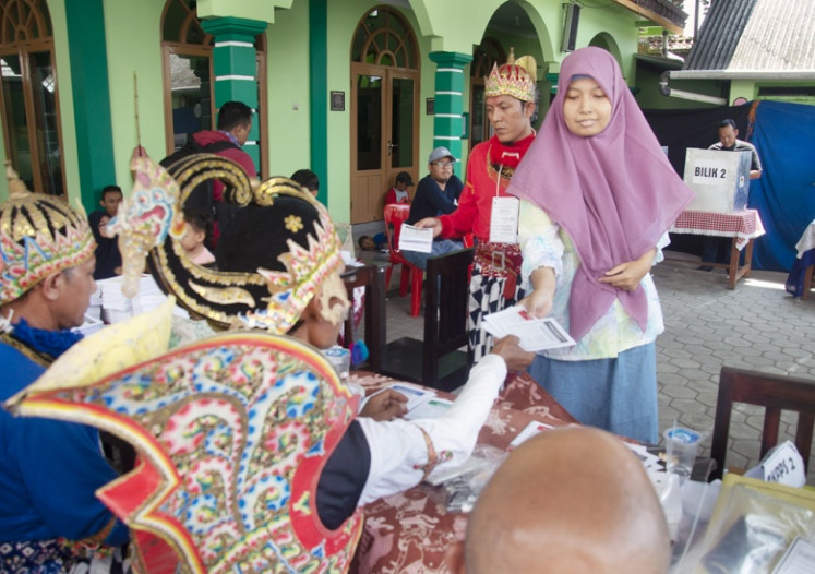 Festive election: Dressed in traditional Javanese attire, poll workers serve voters in Giwangan subdistrict in Yogyakarta in the April 2019 legislative election.