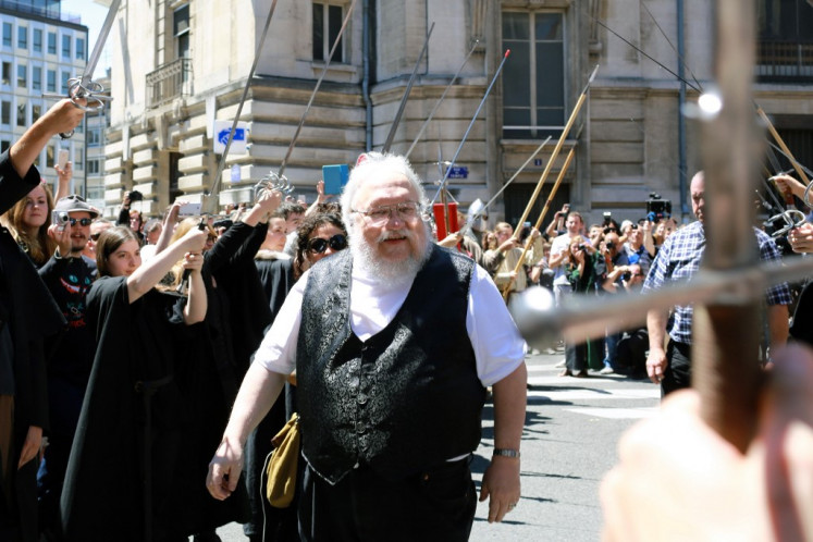 The author of the book 'Game of Thrones', George RR Martin, arrives to attend a book signing on July 3, 2014 in Dijon, France, awaited by over 1,000 fans.