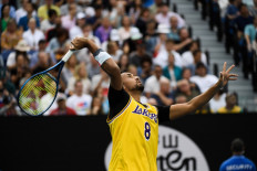 Australia's Nick Kyrgios wears a Los Angeles Lakers jersey with former basketball player Kobe Bryant's number warms up to play against Spain's Rafael Nadal during their men's singles match on day eight of the Australian Open tennis tournament in Melbourne on Monday, Jan. 27, 2020.