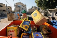 Jordanian woman Saada Turkmani collects empty metal cans in a dedicated container before she transports it to the station as part of a women-run program to improve Jordan's solid waste management, at the Northern town of Shouneh in the Jordan Valley, Jordan, January 15, 2020.