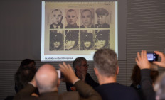 Journalists watch a projection of pictures showing allegedly John Demjanjuk during a press conference on newly discovered photos from Sobibor Nazi death camp on January 28, 2020 in Berlin. 