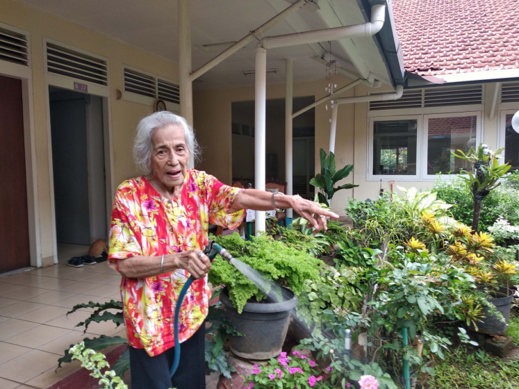 Soeprapti Soetedjo waters plants in her garden in front of her room at the Sasana Tresna Werdha Ria Pembangunan. Gardening is her number one hobby and she still does it every day at the age of 95.