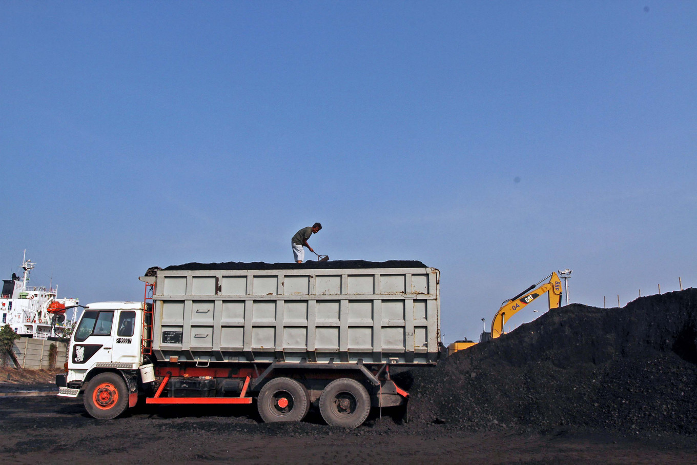 A worker loads coal at Cirebon Port in West Java in this undated file photo.