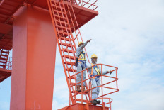 Workers of PT KCIC observe the construction of the high-speed railway connection between Jakarta and Bandung in this undated photograph.