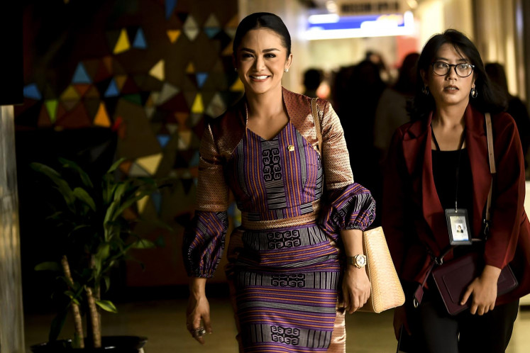 Singer and lawmaker Kris Dayanti arrives for the commemoration of the 47th anniversary of the Indonesian Democratic Party of Struggle (PDI-P) at the House of Representatives in Jakarta on Feb. 10, 2020. 