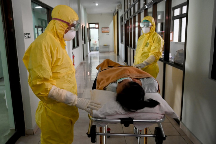 Health workers wearing protective gear take part in an exercise in handling a suspected patient at Sanglah hopital in Denpasar, Bali, on Feb. 12.