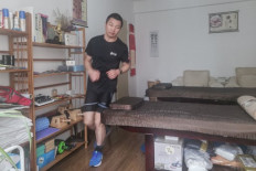 This handout picture taken and released courtesy of Pan Shancu on Feb. 14, shows Pan Shancu running in his bedroom in Hangzhou, China's eastern Zhejiang province.