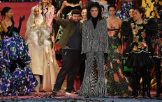 British fashion designer Richard Quinn (centre L) poses with his models after presenting his catwalk show for the Autumn/Winter 2020 collection on the second day of London Fashion Week in London on February 15, 2020.
