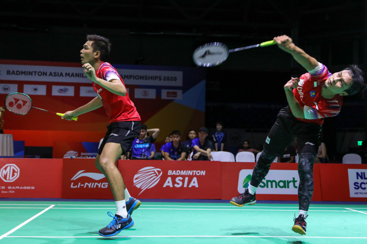 Newly formed men's doubles pair Fajar Alfian (left) and Mohammad Ahsan of Indonesia compete against Ong Yew Sin and Teo Ee Yi of Malaysia in the final of the 2020 Asia Team Championships in Manila on Sunday. The pair won the match to seal the title for Indonesia.