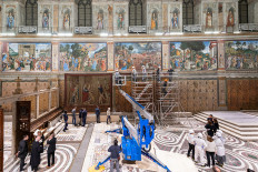 A tapestry designed by Renaissance artist Raphael is installed on a lower wall of the Sistine Chapel at the Vatican as part of celebrations marking the 500th anniversary of his death in this handout photo released on February 17, 2020. 