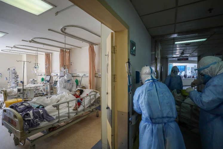 This photo taken on February 16, 2020 shows medical staff members working at the isolation ward of the Wuhan Red Cross Hospital in Wuhan in China's central Hubei province.